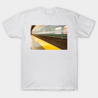 Platform with yellow line railway tracks blurred in motion blur aws train passes. T-Shirt